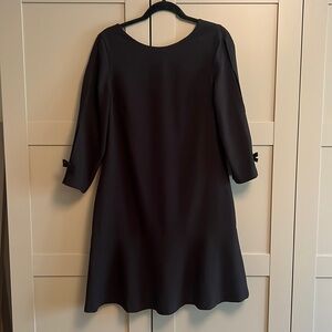 Short black cocktail dress with sleeve detail.